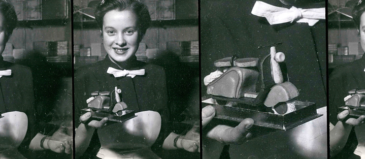 Black and white old picture of a woman holding a marzipan figure.