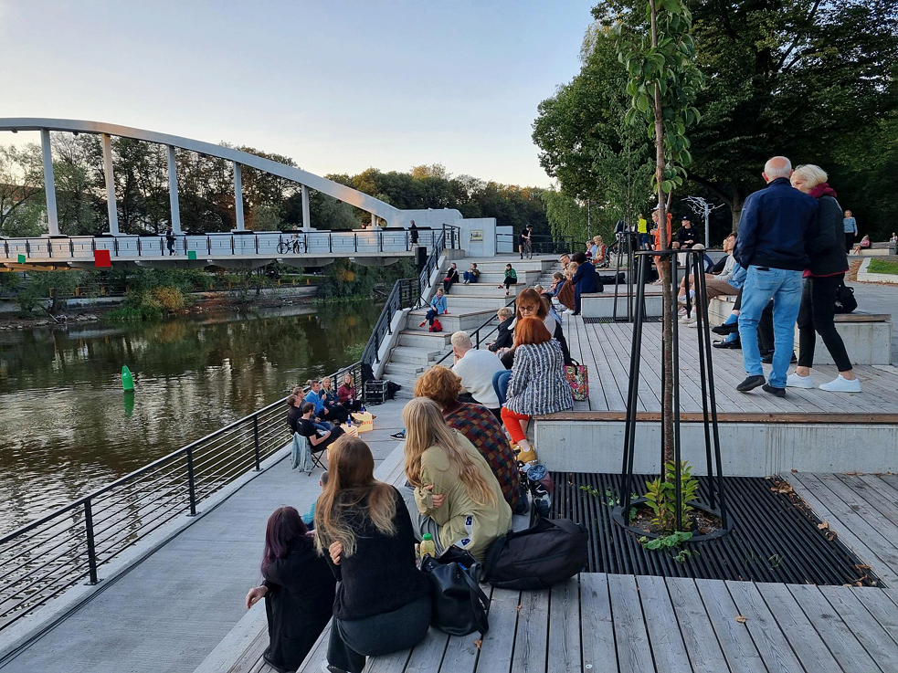 People sitting in front of the river bank